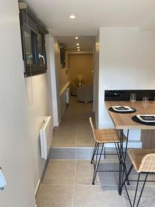 a kitchen and living room with a table and chairs at Le cocon de Laurie in Bons +7 photos