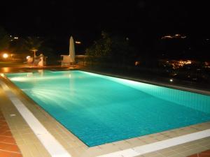a swimming pool lit up at night at Villa Gioia in Ischia