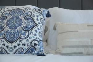 a bed with two pillows and a blue and white pillow at Luton Nook and Kitchen 4 mins to Luton AirPort in Luton +36 photos