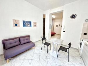 a living room with a couch and a table and chairs at A due passi dal Centro Intero appartamento con AC e WiFi in Forlì