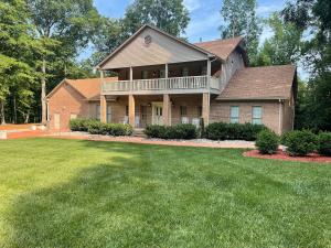 a house with a large yard in front of it at Whisper Chateau Weddings Reunions Groups 75 Plus in Greensboro