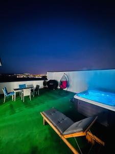 a balcony with a pool and a table and chairs at Luxury Penthouse Belvedere in Sibiu