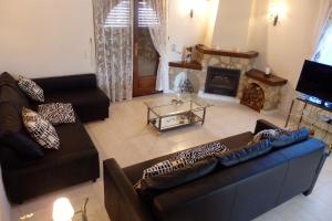 a living room with two couches and a fireplace at Meddays Villa Norli in Miami Platja