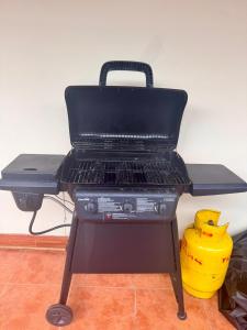 a bbq grill in a room with a yellow bucket at Casa Bella in Esquipulas +31 photos