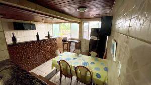 a kitchen with a table and chairs in a room at Pousada da Praia Frade in Angra dos Reis