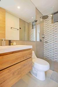 a bathroom with a toilet and a sink and a shower at Amazing 2BR Apartament with pool in Santa Marta in Santa Marta