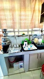 a kitchen with a counter top with dishes on it at Riverside apartment in Nairobi +5 photos