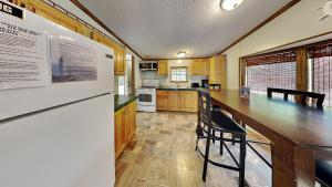 a kitchen with a large wooden table and chairs at Put-in-Bay Island Club #51 in Put-in-Bay