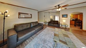 a living room with a leather couch and a table at Put-in-Bay Island Club #51 in Put-in-Bay