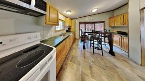 Una cocina con gabinetes de madera y una mesa con sillas. en Island Club #51, en Put-in-Bay