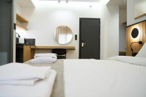 a bedroom with two beds and a mirror at 42 Studio 8 in Komotini