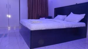 A bed or beds in a room at Prominent Hotel and Suites