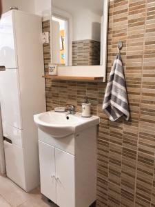 a bathroom with a sink and a mirror at Middle of the city apartmann in Pécs