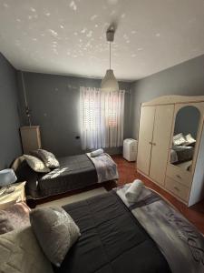 a bedroom with two beds and a mirror at Vv Las Vistas in Icod de los Vinos +14 photos