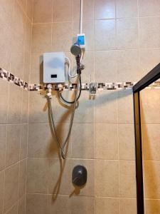 a shower with a shower head in a bathroom at Casa Bella in Esquipulas