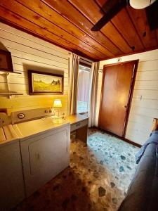 a room with a desk with a lamp in it at Cedar Wood Lodge Wkayaks & Canoes, Outdoor Dining in Karnack