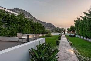 a garden with a table and chairs on a building at Coco-Mat Efterpi House by Plakias Suites in Plakias