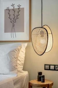 a bedroom with a bed and a pendant light at Coco-Mat Efterpi House by Plakias Suites in Plakias +13 photos