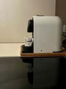 a coffee maker and a coffee cup on a table at Coco-Mat Efterpi House by Plakias Suites in Plakias