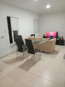 a living room with a couch and a table and chairs at Dpto Posadas in Junín