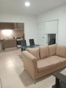 a living room with a couch and a table at Dpto Posadas in Junín