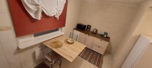 a small kitchen with a wooden table in a room at Marja Apartment in Tartu