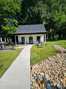 a house with a walkway leading into a yard at Life's Especially Good Retreat in Brevard