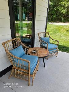 two wicker chairs and a table on a porch at Life's Especially Good Retreat in Brevard