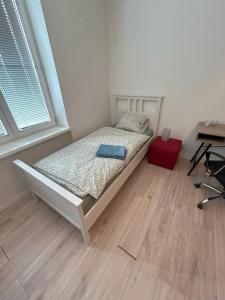 a bedroom with a bed in a room with a desk at Apartment Česká 23 in Koliba