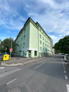 a green building on the side of a street at Apartment Česká 23 in Koliba