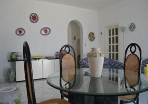 a glass table with a vase on top of it in a kitchen at Villa Gioia in Ischia