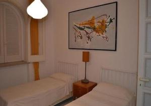 a room with two beds and a picture on the wall at Villa Gioia in Ischia +18 photos