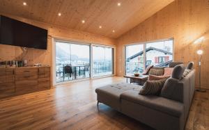 a living room with a couch and a flat screen tv at Ferienwohnung Alexander Kleinheinz in Rettenberg