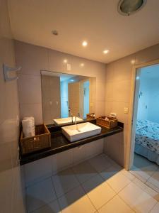 a bathroom with a sink and a mirror at Casa Vista ao Mar - Paisagem Deslumbrante e Localização Perfeita in Canoa Quebrada
