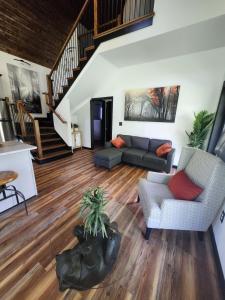 a living room with a couch and a table at Life's Good Retreat Bear Cottage in Brevard