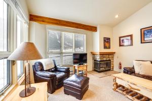 a living room with leather furniture and a fireplace at Copper Mtn Resort Duplex with Golf Course Views! in Frisco