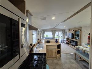 a kitchen with a sink and a counter top at Whitstable Neptune in Kent