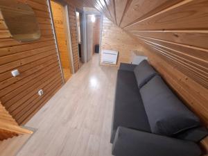 an overhead view of a couch in a tiny house at Anaičių sodyba in Palanga +3 photos