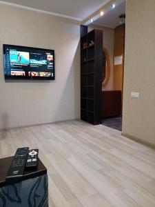 a room with a flat screen tv on the wall at Apartment with balcony on Peremohy Avenue 43 in Chernihiv