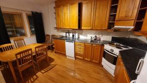 a kitchen with wooden cabinets and a counter top at Hiihtäjänkuja 5A4, Levi in Levi