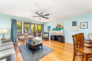 a living room with a couch and a table at Your Maui Getaway-Walk to the Beach, Pool, Hot Tub LSV14 in Kihei