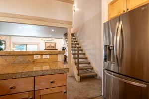 a kitchen with a stainless steel refrigerator and a staircase at Sunburst Condo 2786 in Sun Valley