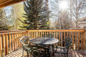 a table and chairs on a wooden deck at Sunburst Condo 2786 in Sun Valley