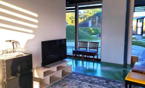 a living room with a flat screen tv on a wall at Kaze no iro Bijutsukan - Vacation STAY 29975v in Asahi