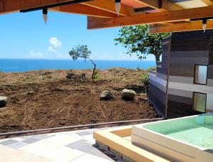 a view of the ocean from a house with a hot tub at Kaze no iro Bijutsukan - Vacation STAY 29904v in Asahi