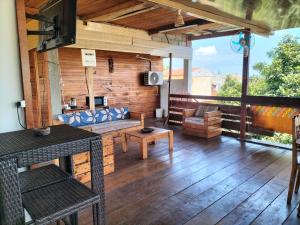 a living room with a couch and a table at Monteiro Paradise Guest House in São Tomé