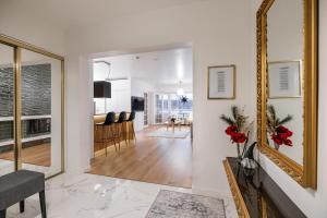 a living room with a mirror and a dining room at Northern Lights River in Rovaniemi