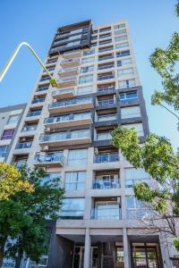 a tall building with a street light in front of it at Departamento 2 Premium con Cochera y Piscina in Bahía Blanca