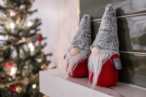 a sock monkey dolls sitting next to a christmas tree at Northern Lights River in Rovaniemi
