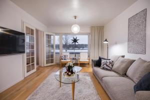 a living room with a couch and a table at Northern Lights River in Rovaniemi